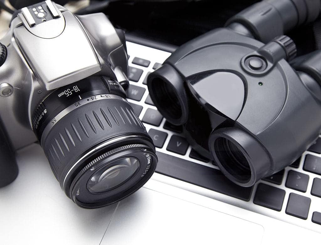 Image featuring essential tools of our trade, including a camera, a pair of binoculars, and a laptop, representing the comprehensive investigative services offered by Hanuman Investigation in Thailand.